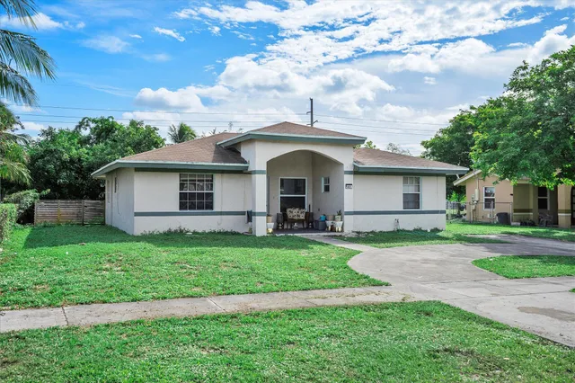 a front view of a house with a garden