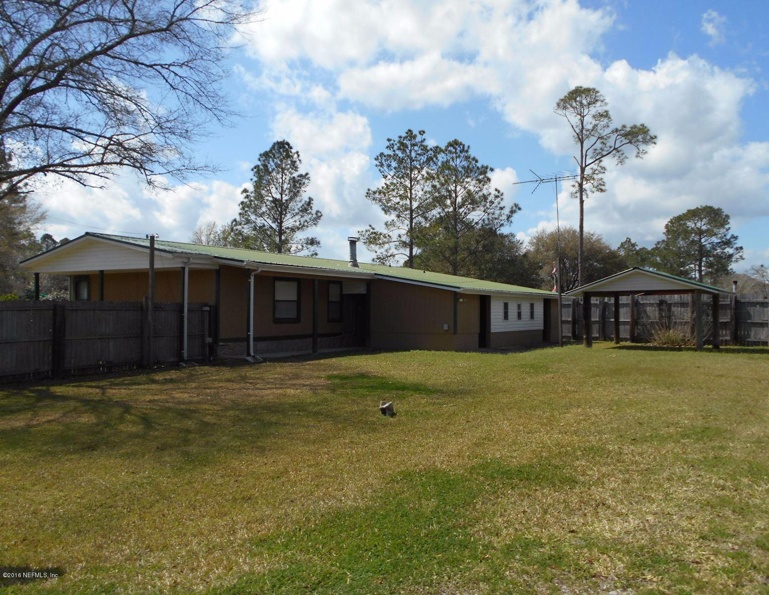 75179 Randy Road Yulee, FL 32097 - Photo 5 of 56 a front view of a house with a garden