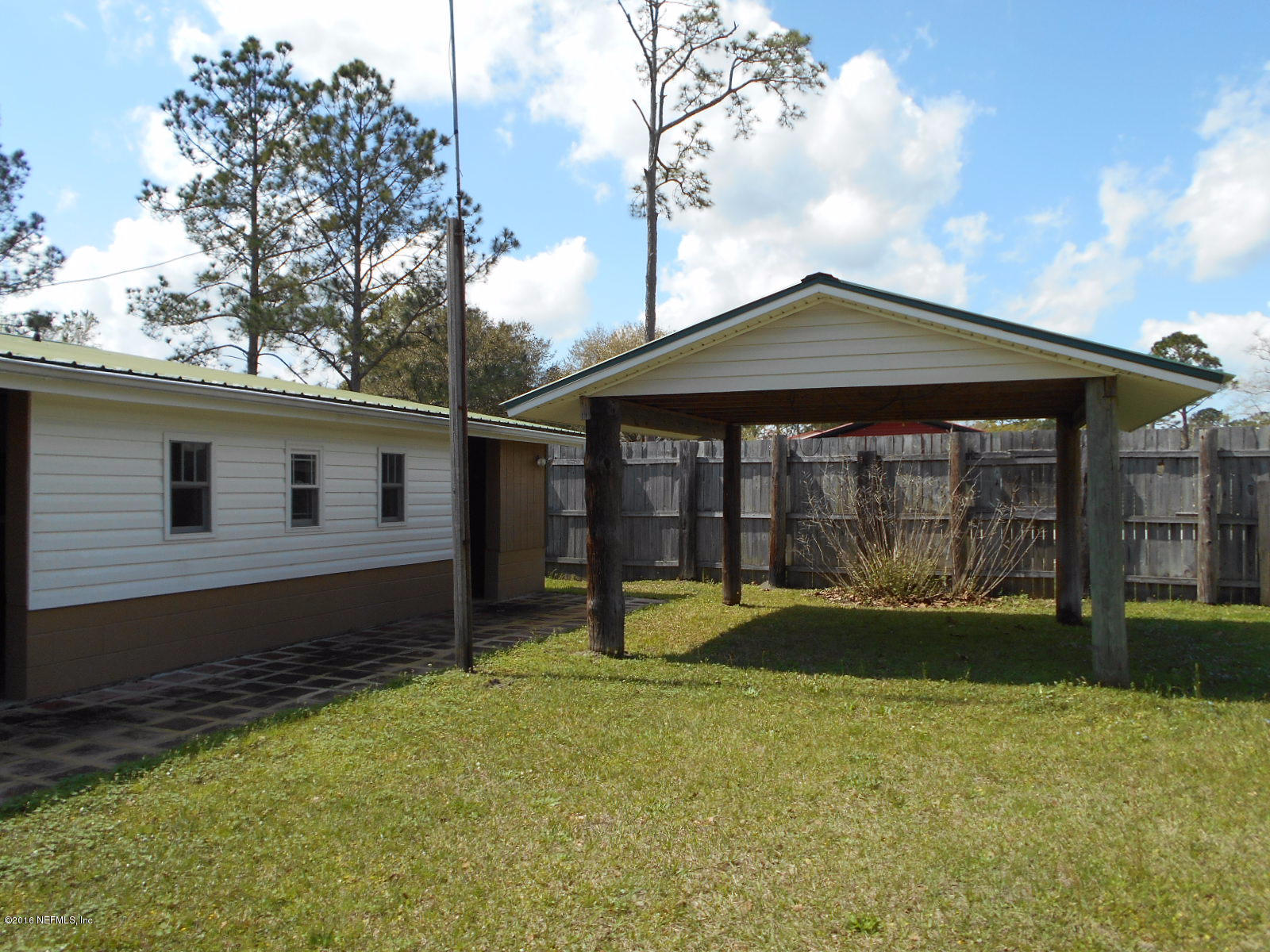 75179 Randy Road Yulee, FL 32097 - Photo 6 of 56 a front view of a house with a yard