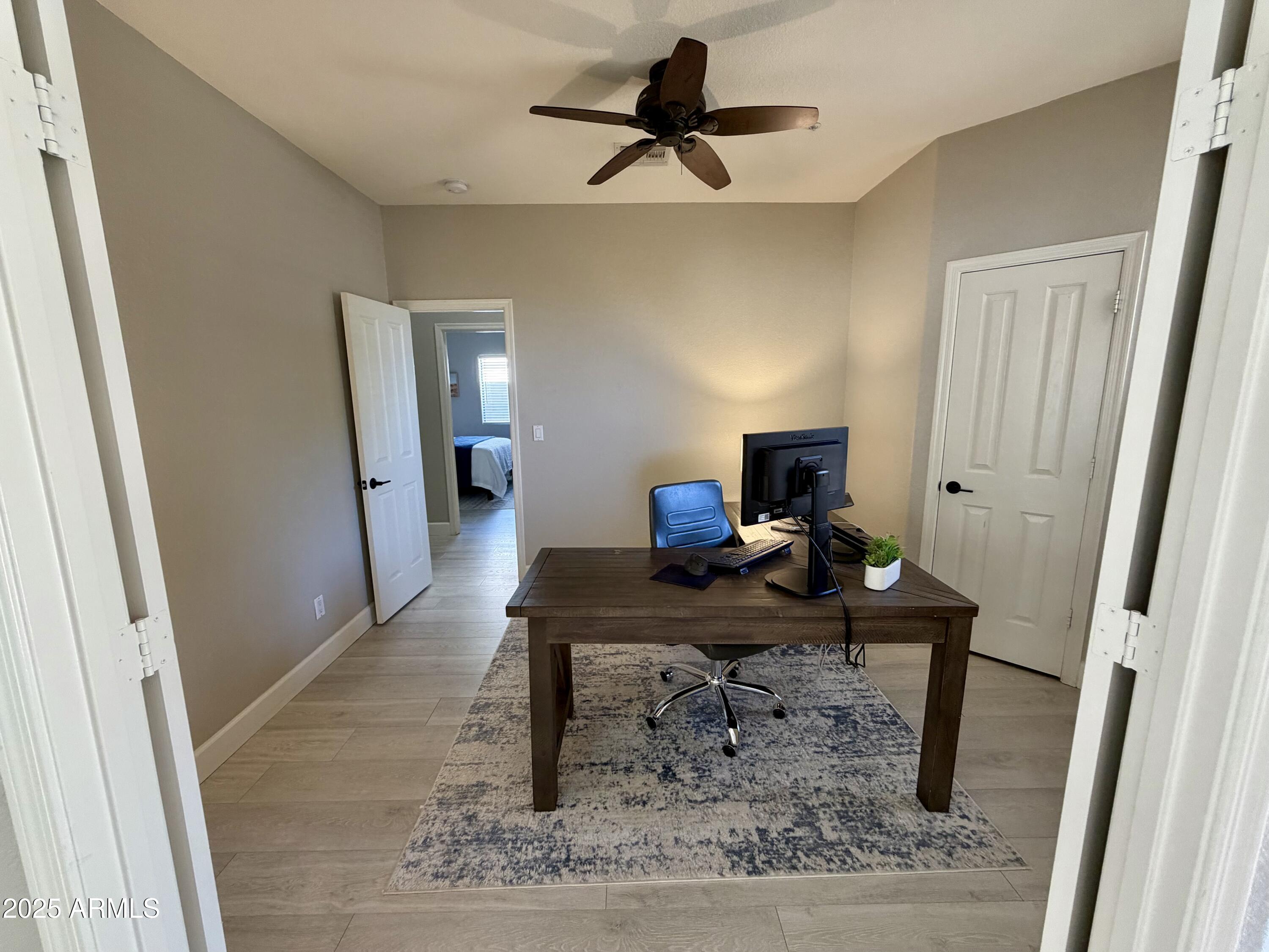 3068 North 83rd Place Scottsdale, AZ 85251 - Photo 12 of 46 a view of a workspace with furniture and wooden floor