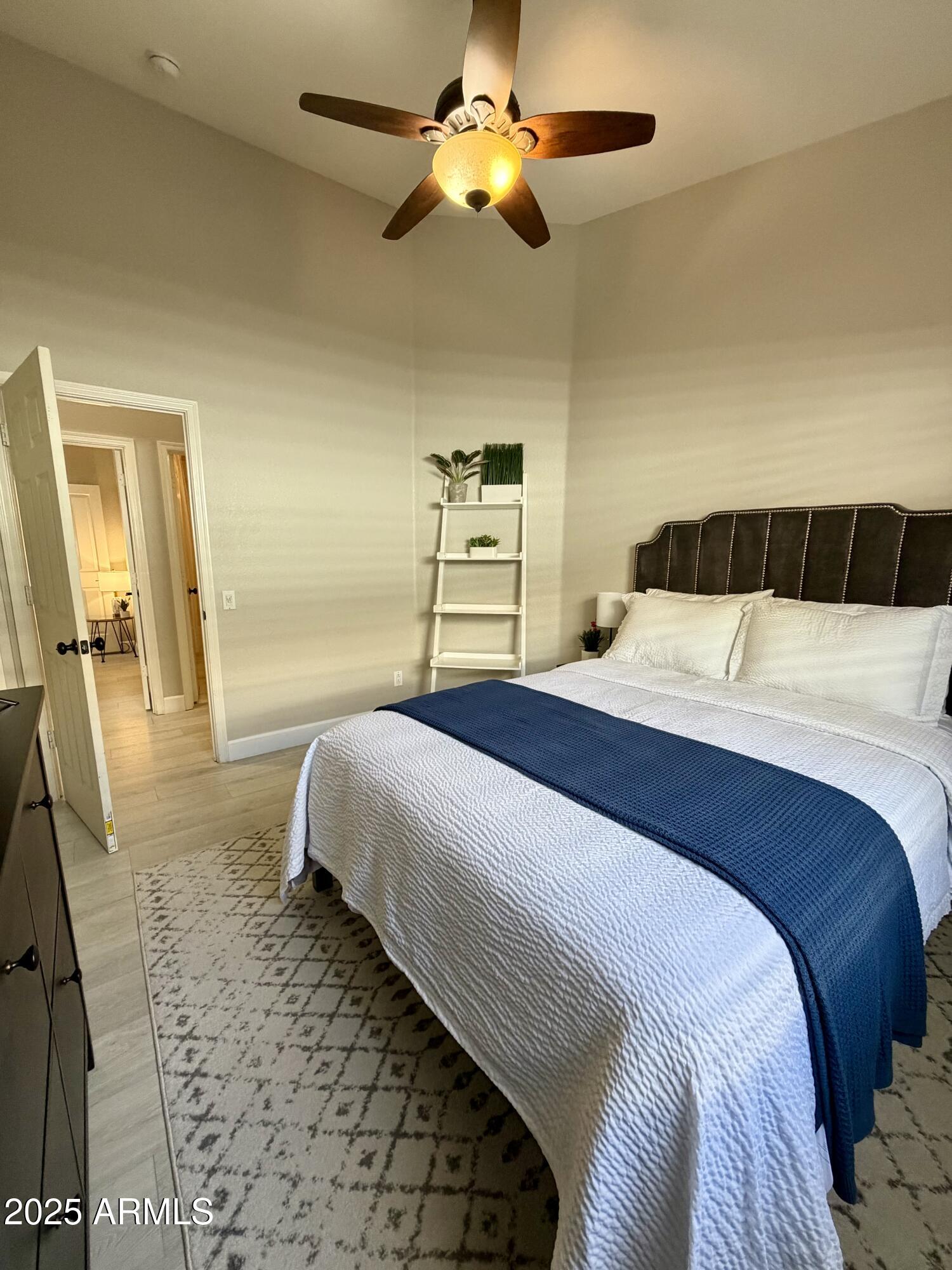 3068 North 83rd Place Scottsdale, AZ 85251 - Photo 22 of 46 a bedroom with a large bed and a chandelier