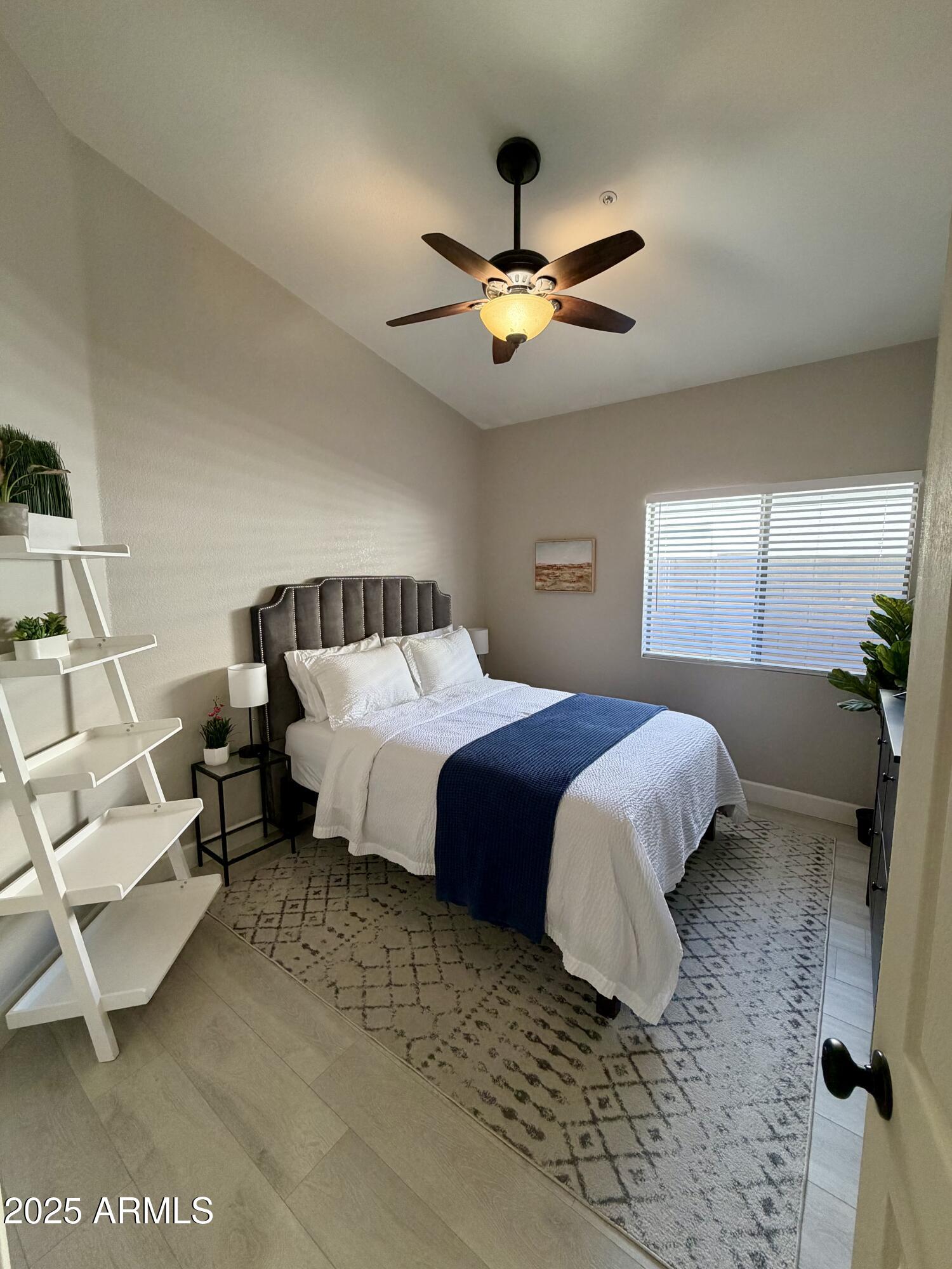 3068 North 83rd Place Scottsdale, AZ 85251 - Photo 27 of 46 a bedroom with a bed and a chandelier