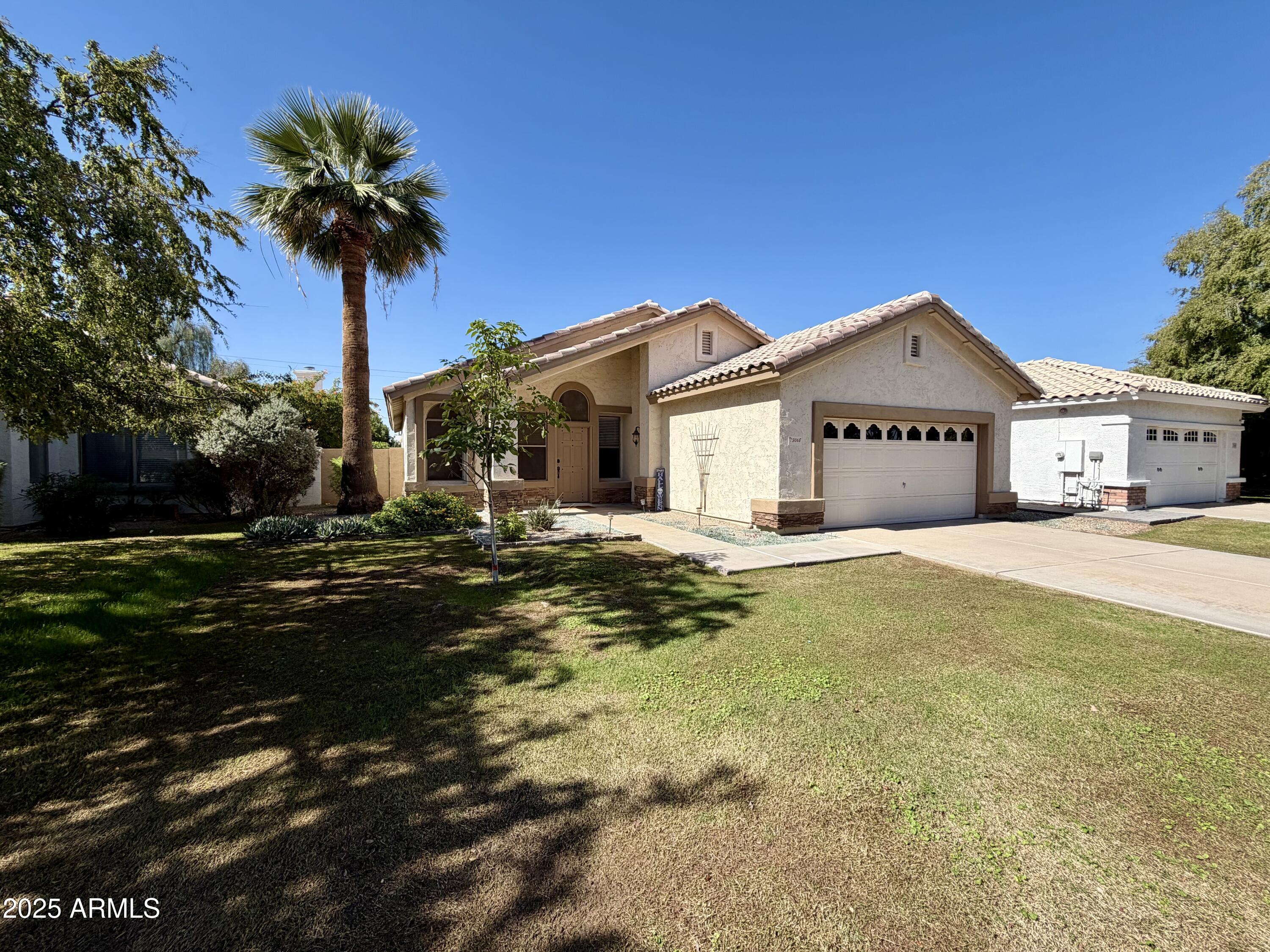 3068 North 83rd Place Scottsdale, AZ 85251 - Photo 3 of 46 a front view of a house with a garden and palm tree
