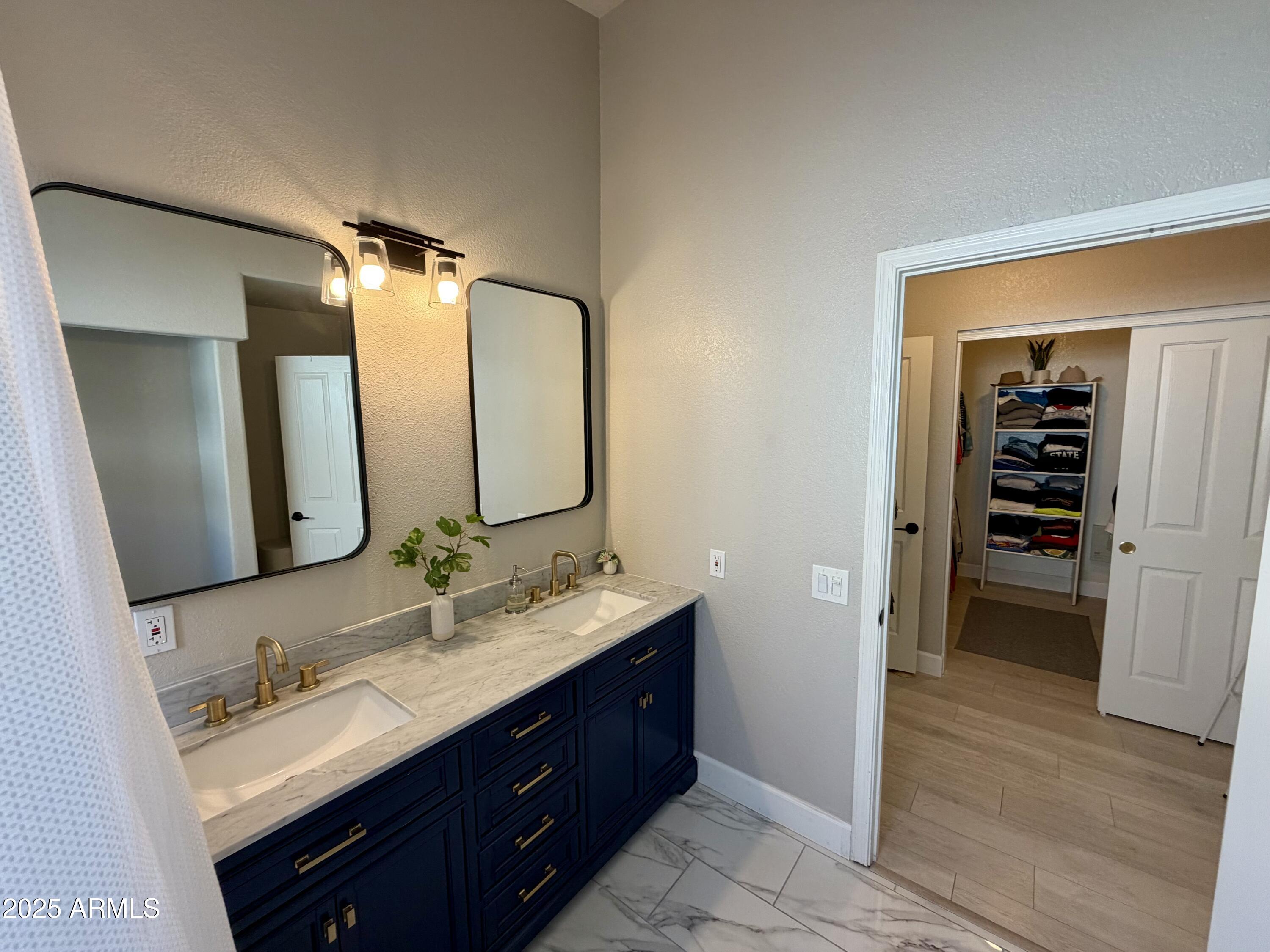 3068 North 83rd Place Scottsdale, AZ 85251 - Photo 34 of 46 a bathroom with a double vanity sink and mirror