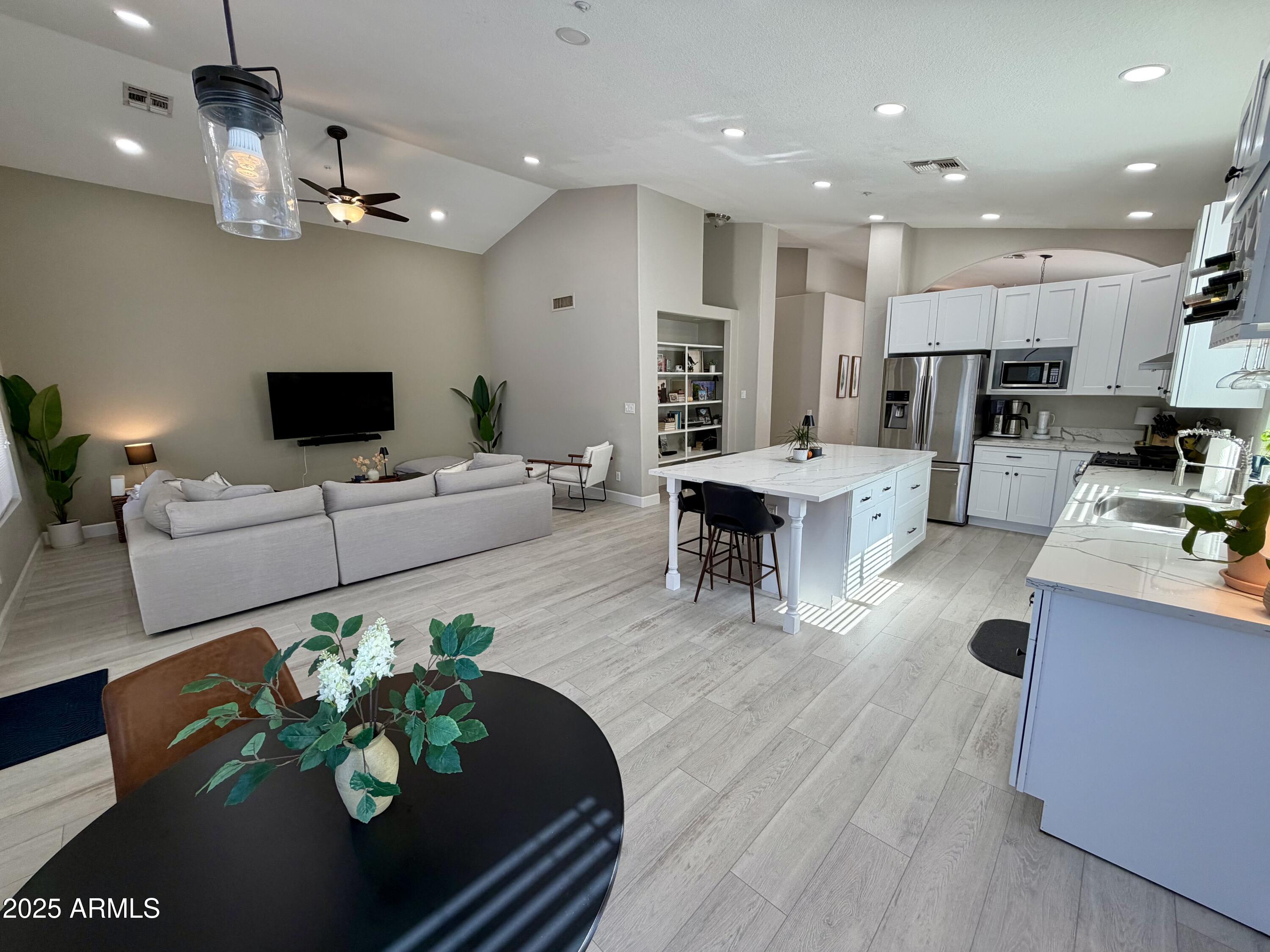 3068 North 83rd Place Scottsdale, AZ 85251 - Photo 9 of 46 a living room with furniture kitchen view and a wooden floor