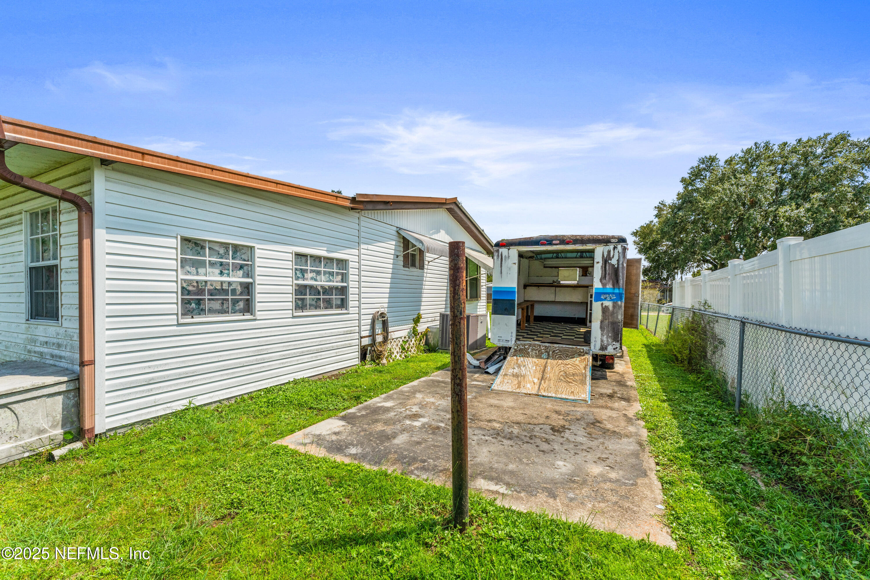116 Iowa Street Crescent City, FL 32112 - Photo 24 of 25 a front view of a house with a yard and garage