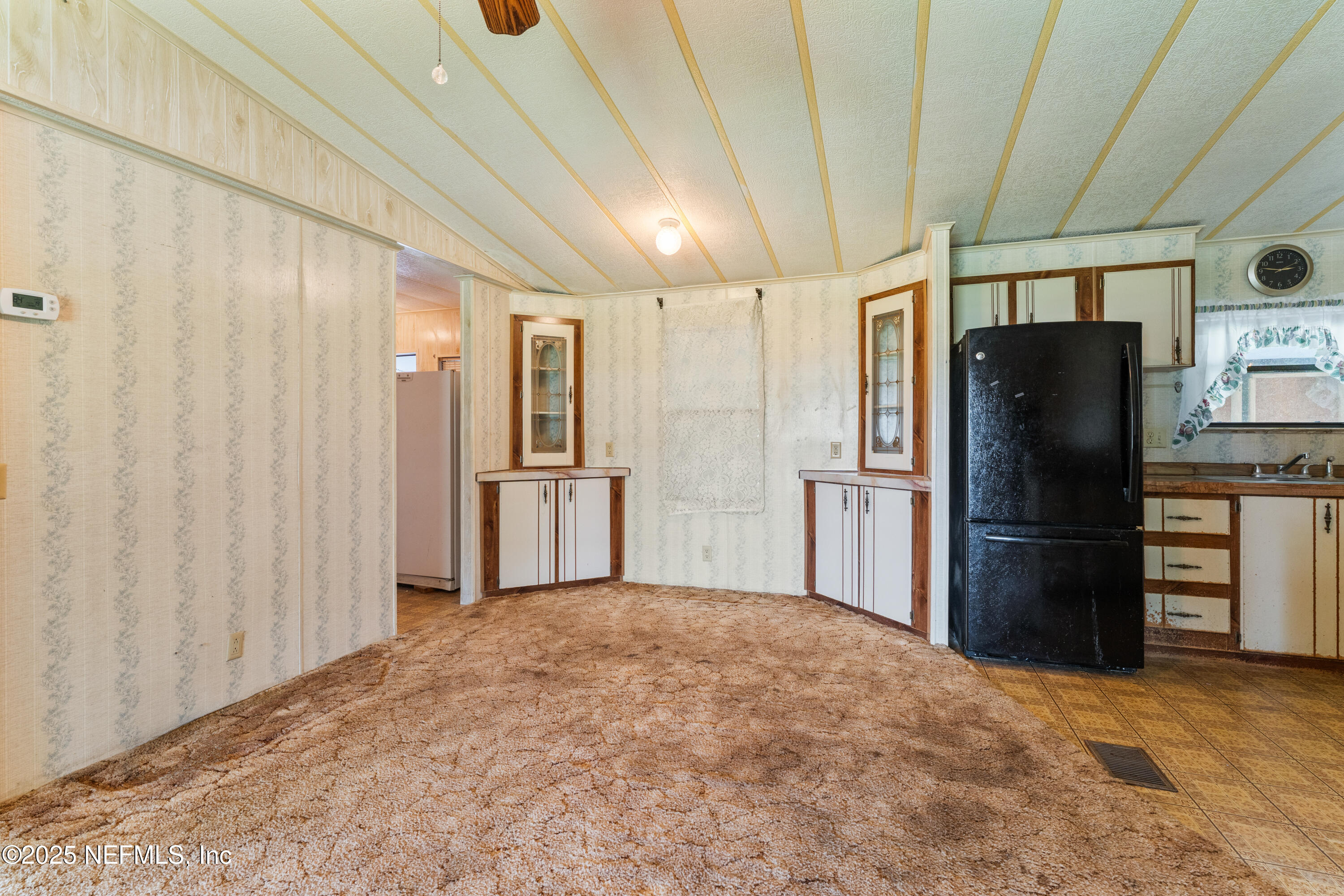 116 Iowa Street Crescent City, FL 32112 - Photo 8 of 25 a kitchen with stainless steel appliances a refrigerator and a stove