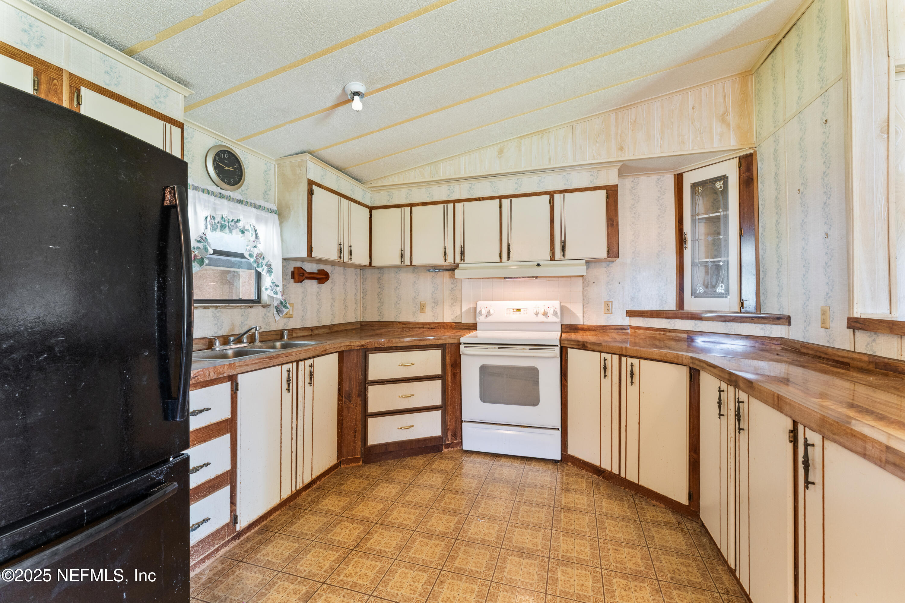 116 Iowa Street Crescent City, FL 32112 - Photo 9 of 25 a kitchen with stainless steel appliances sink cabinets and window