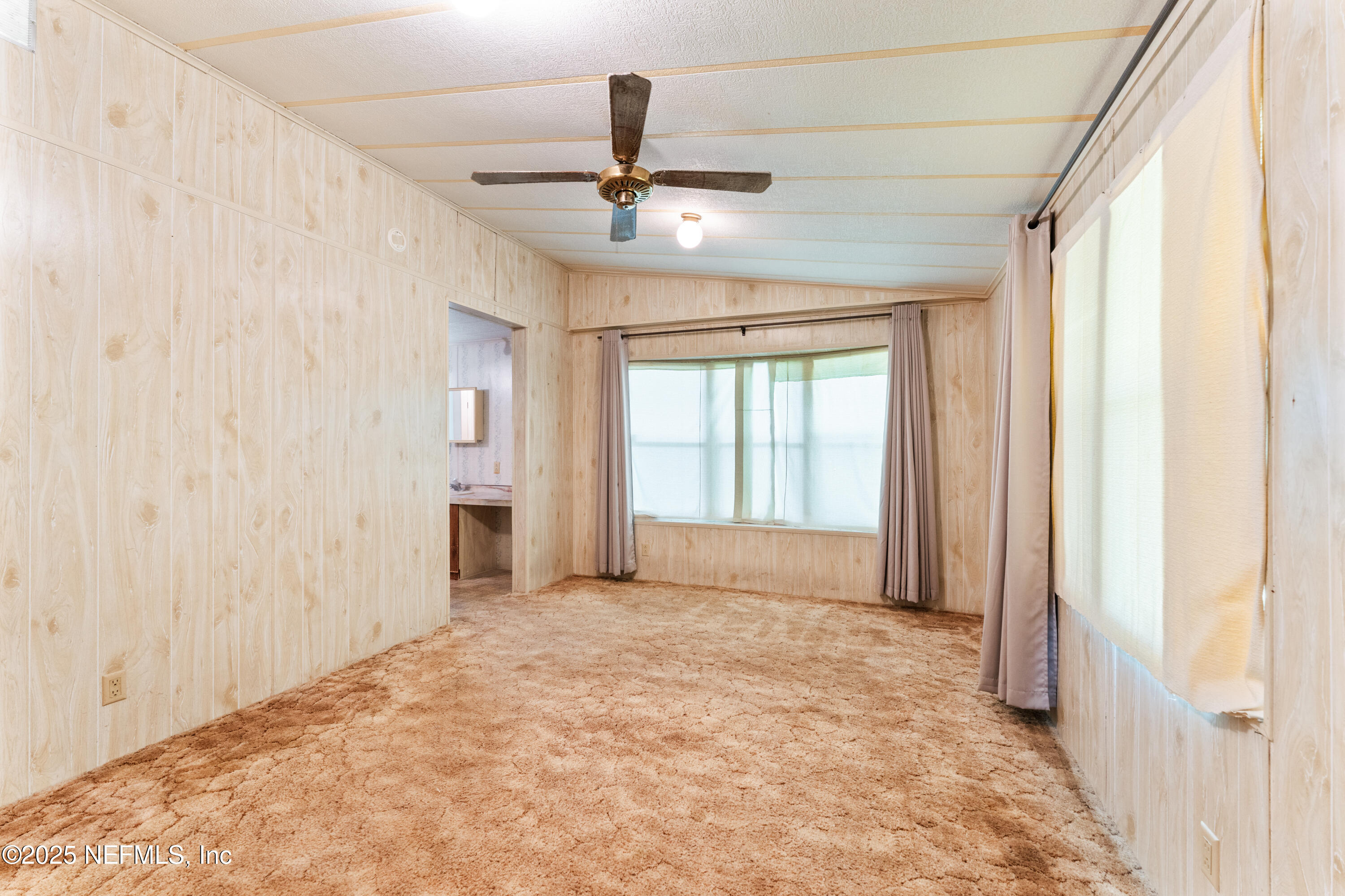 116 Iowa Street Crescent City, FL 32112 - Photo 10 of 25 a view of an empty room and window
