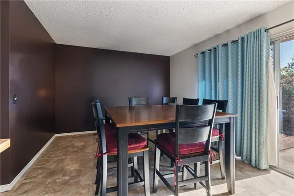 a view of a dining room with furniture and window