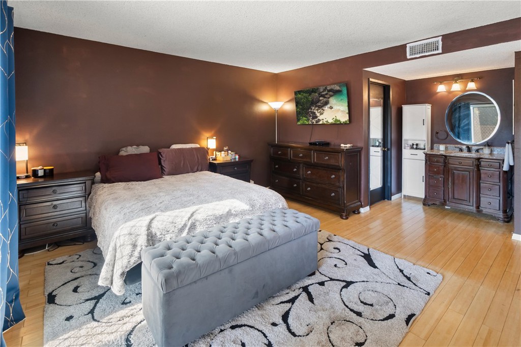 6624 Banyan Place Riverside, CA 92506 - Photo 15 of 41 a bedroom with a bed and a dresser with mirror