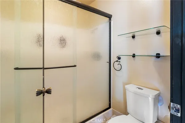 a bathroom with a shower and a toilet