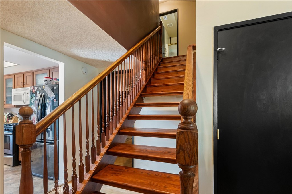 6624 Banyan Place Riverside, CA 92506 - Photo 18 of 41 a view of staircase with wooden floor and white walls