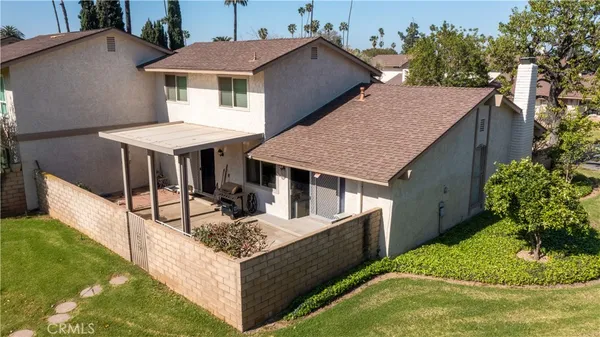 a view of a house with pool and yard