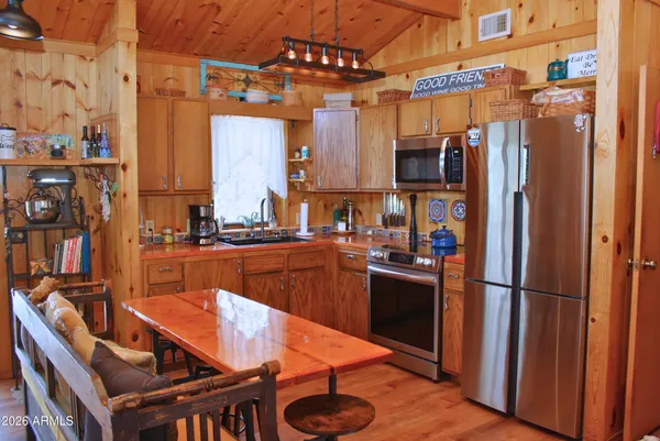a kitchen with stainless steel appliances granite countertop a refrigerator and a stove top oven
