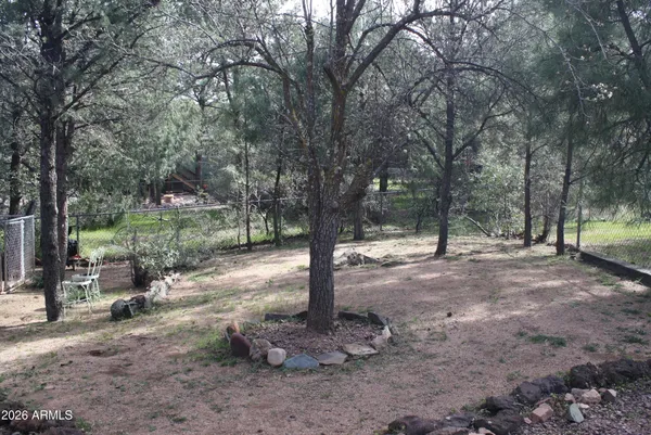 a view of a backyard with a small deck and wooden floor