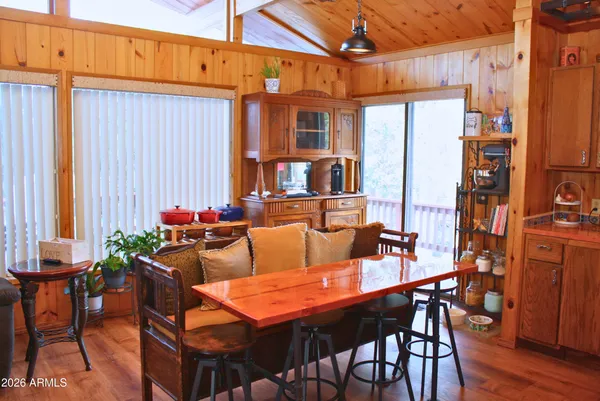 a outdoor dining space with furniture and wooden floor