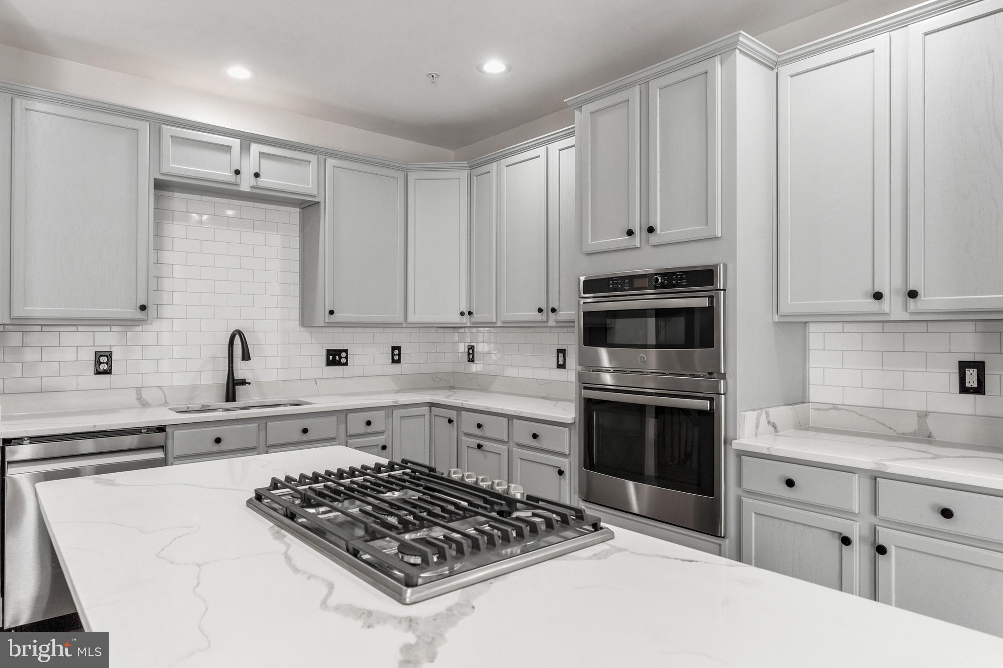 2432 Jostaberry Way Odenton, MD 21113 - Photo 1 of 42 a kitchen with white cabinets and appliances