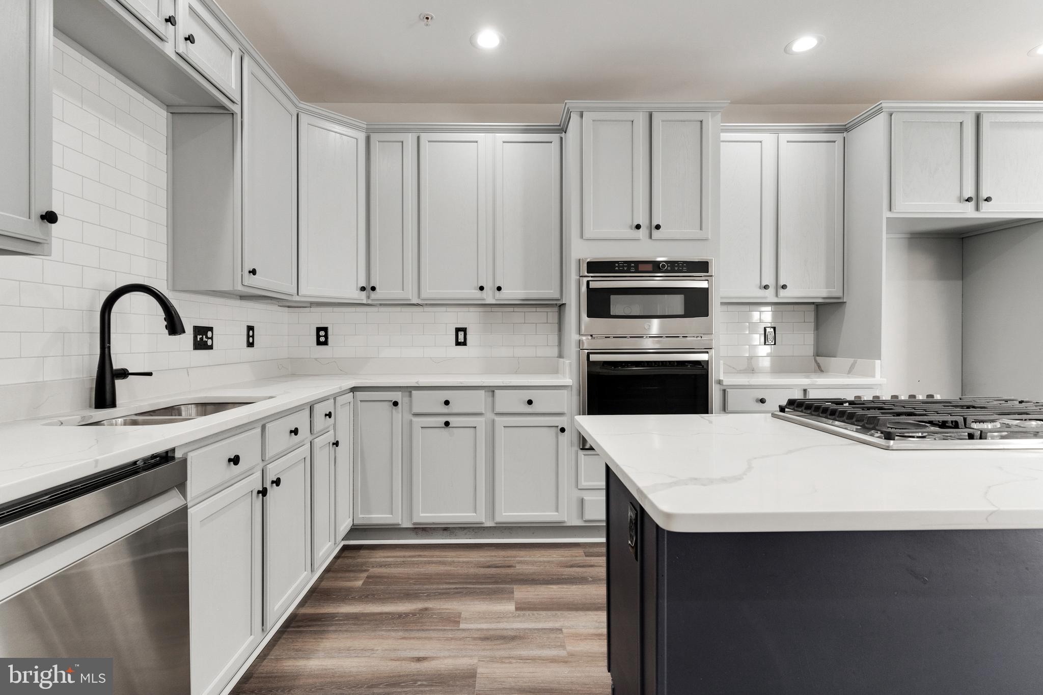 2432 Jostaberry Way Odenton, MD 21113 - Photo 15 of 42 a kitchen with granite countertop a sink stove and refrigerator