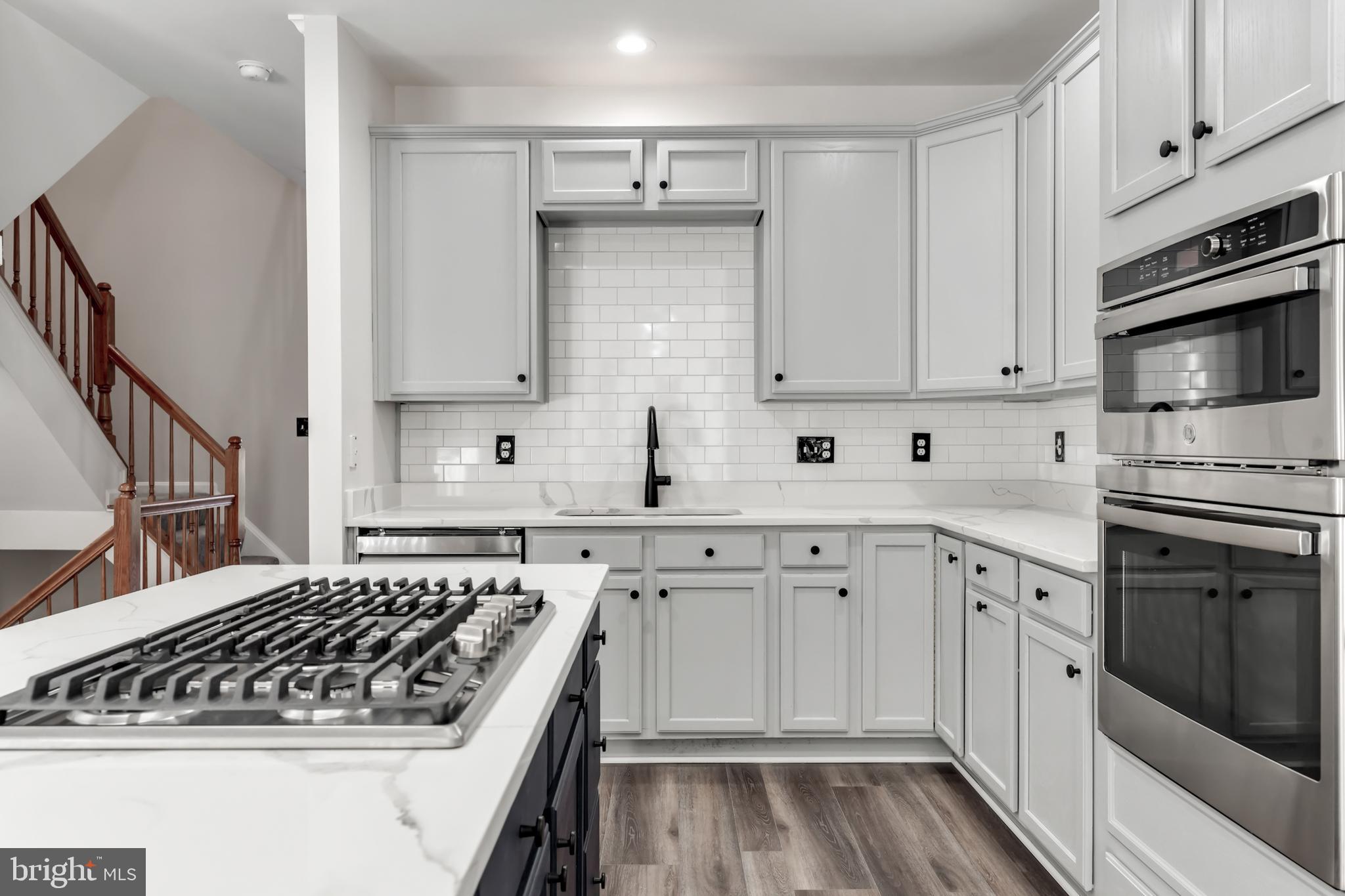 2432 Jostaberry Way Odenton, MD 21113 - Photo 16 of 42 a kitchen with white cabinets and appliances