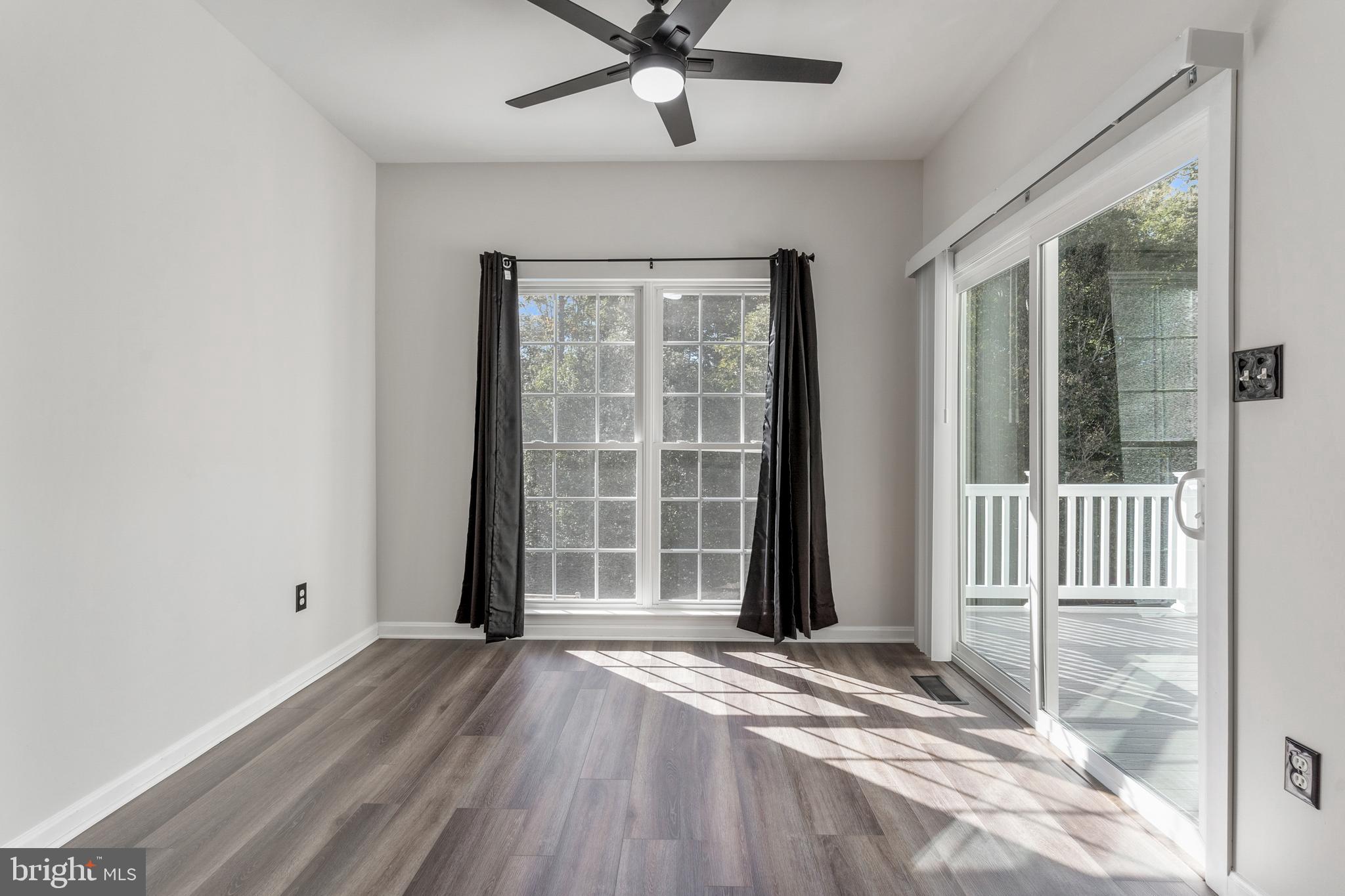 2432 Jostaberry Way Odenton, MD 21113 - Photo 18 of 42 an empty room with wooden floor and windows