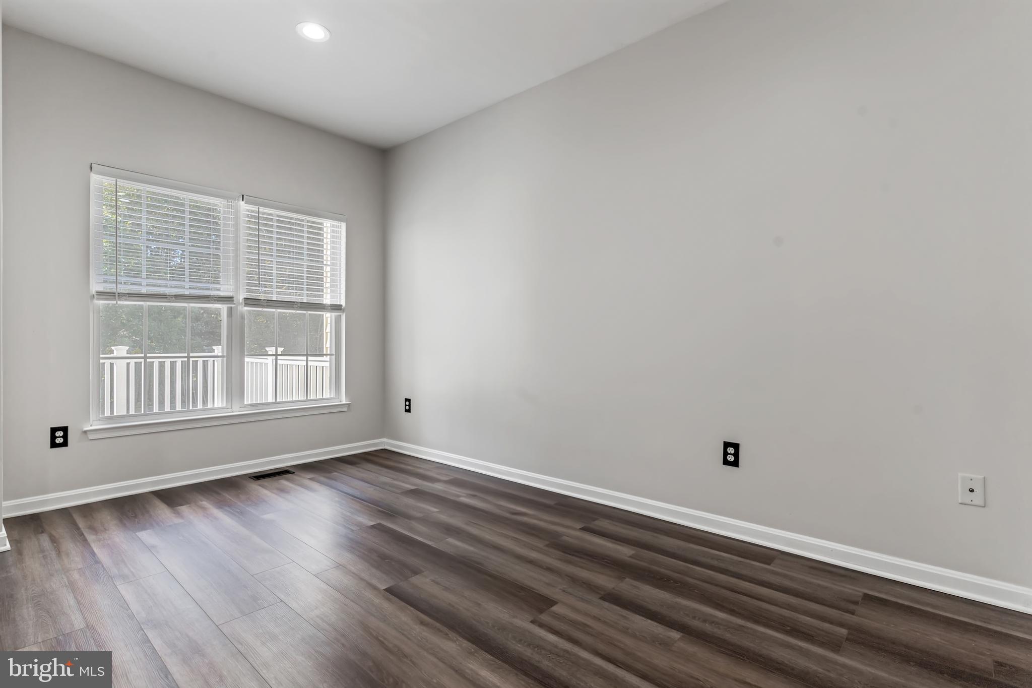 2432 Jostaberry Way Odenton, MD 21113 - Photo 20 of 42 a view of an empty room with wooden floor and a window