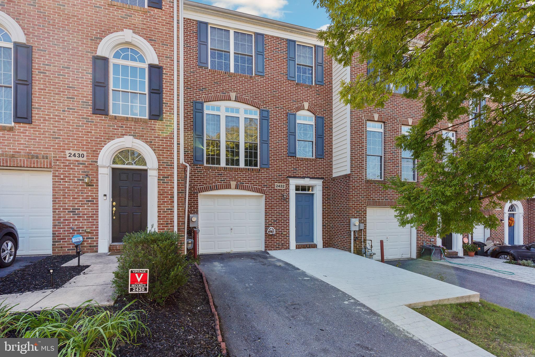 2432 Jostaberry Way Odenton, MD 21113 - Photo 2 of 42 a front view of a house with a yard and garage