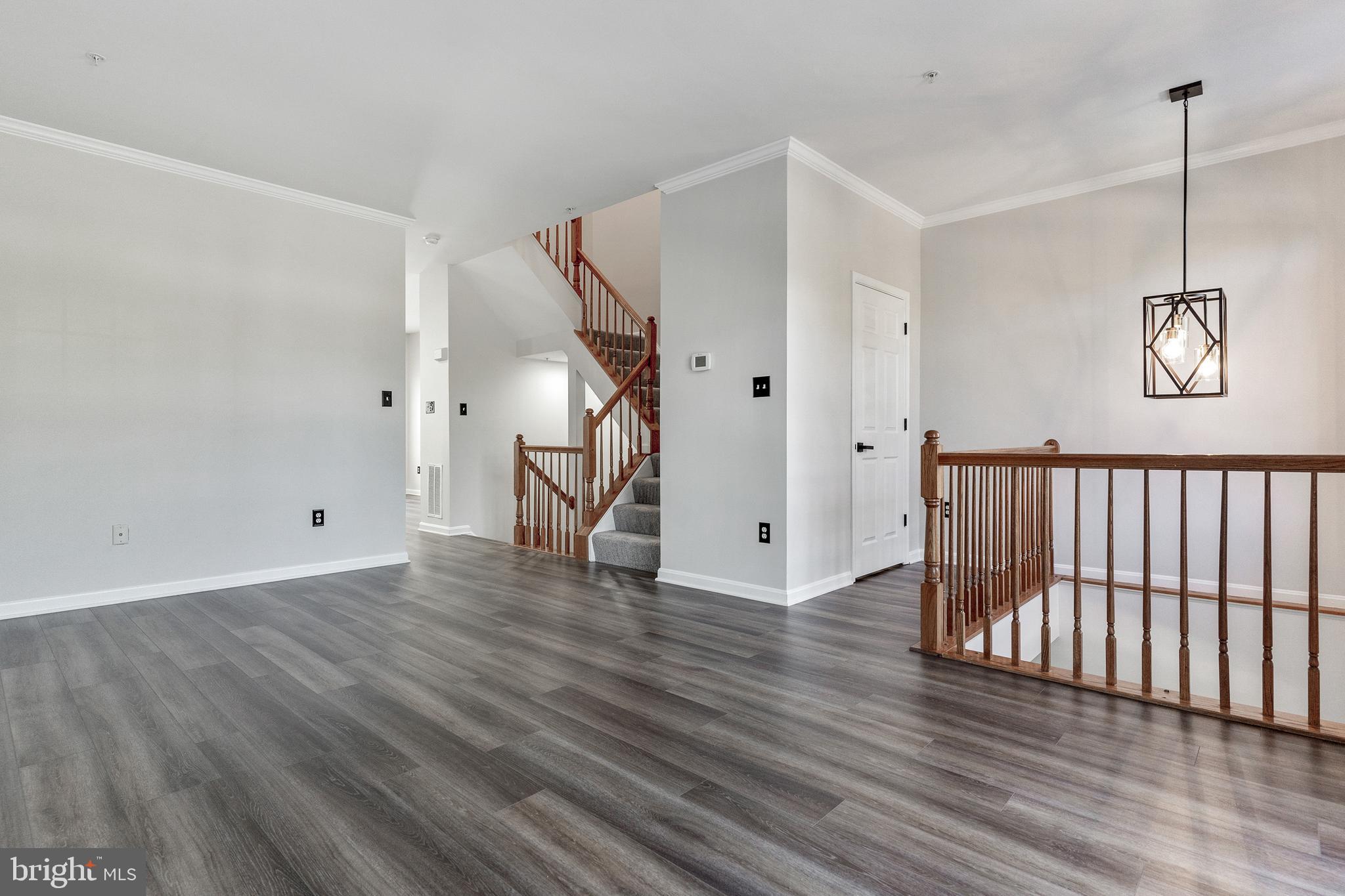2432 Jostaberry Way Odenton, MD 21113 - Photo 21 of 42 a view of an empty room with wooden floor and a ceiling fan