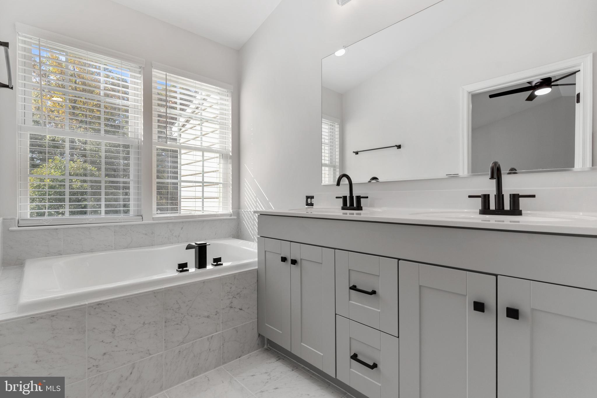 2432 Jostaberry Way Odenton, MD 21113 - Photo 32 of 42 a bathroom with double vanity and a window