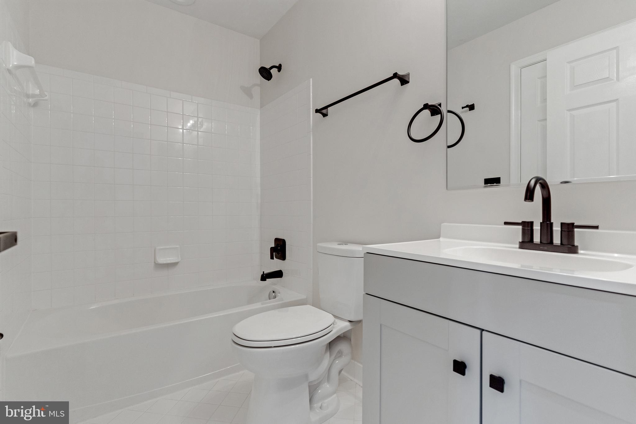2432 Jostaberry Way Odenton, MD 21113 - Photo 37 of 42 a bathroom with a sink a toilet and shower