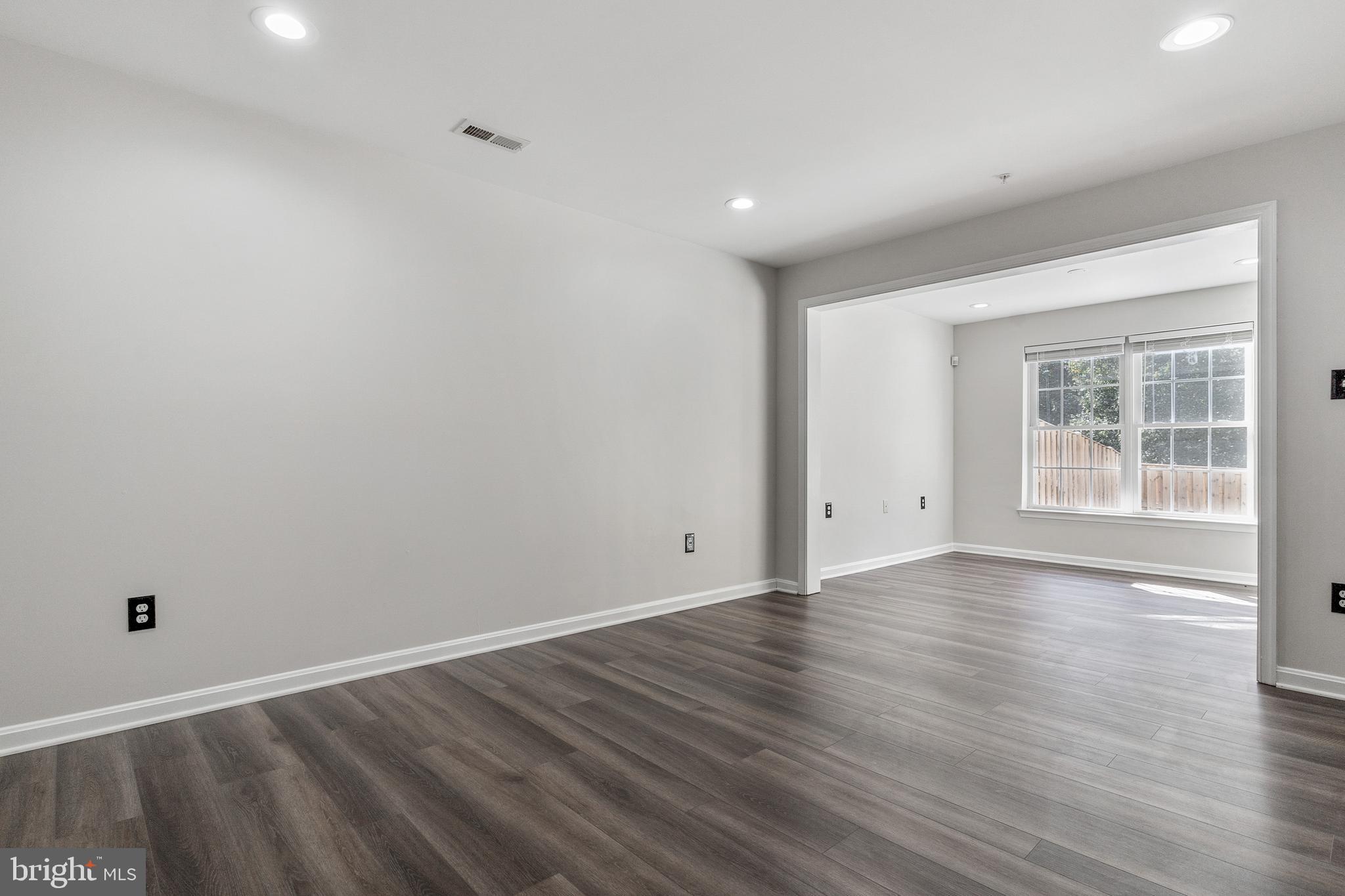 2432 Jostaberry Way Odenton, MD 21113 - Photo 10 of 42 a view of an empty room with wooden floor and a window