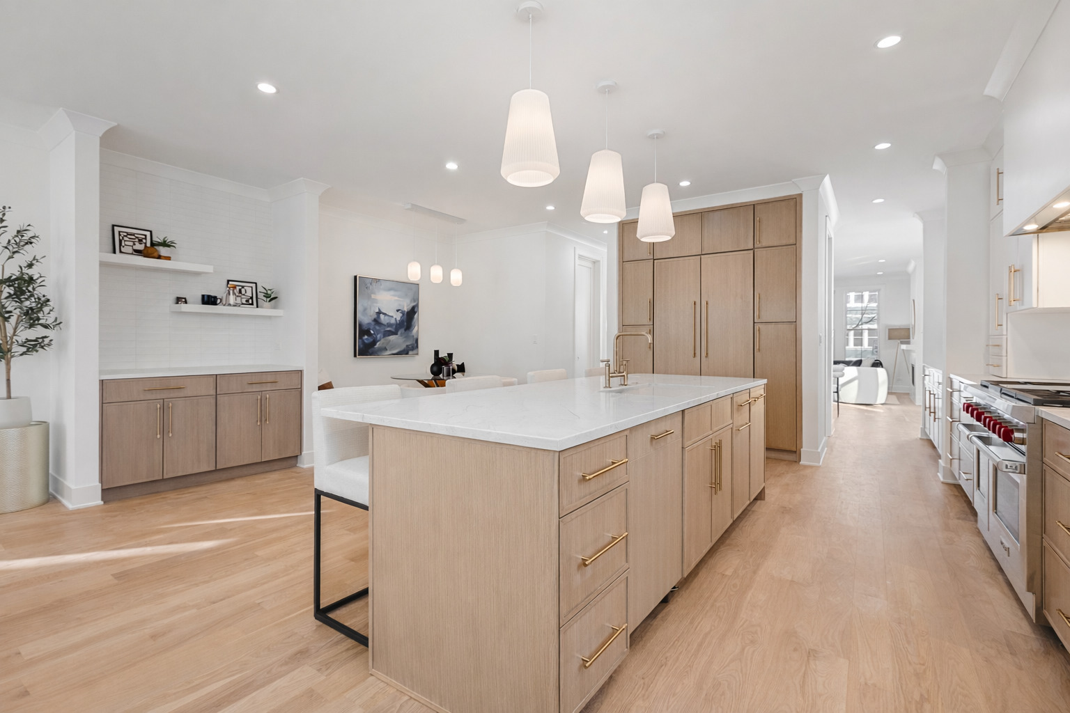 3614 North Marshfield Avenue Chicago, IL 60613 - Photo 14 of 61 a large white kitchen with a large kitchen island white cabinets and stainless steel appliances