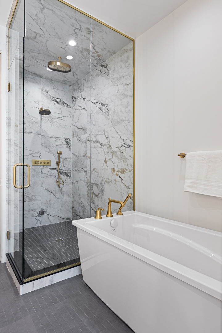 3614 North Marshfield Avenue Chicago, IL 60613 - Photo 28 of 61 a bathroom with a tub and a shower