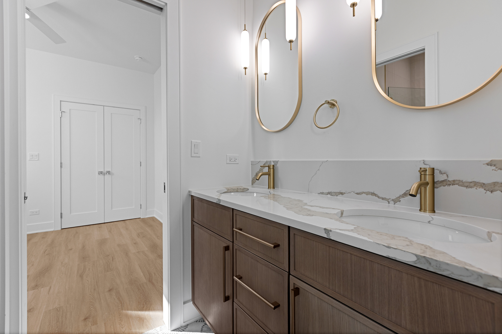 3614 North Marshfield Avenue Chicago, IL 60613 - Photo 47 of 61 a bathroom with a double vanity sink and a mirror