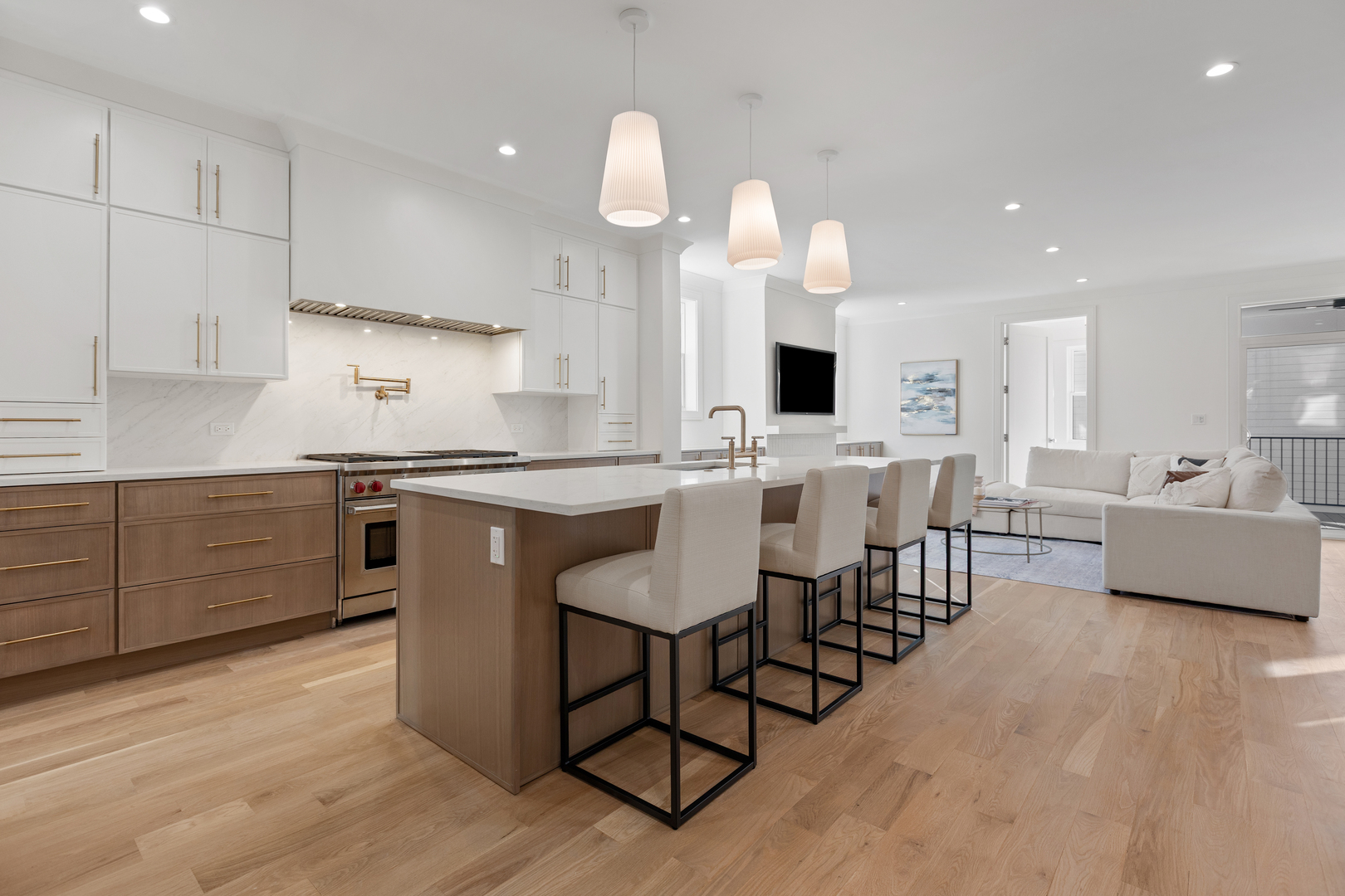 3614 North Marshfield Avenue Chicago, IL 60613 - Photo 8 of 61 an open kitchen with granite countertop a stove a sink a dining table and chairs with wooden floor