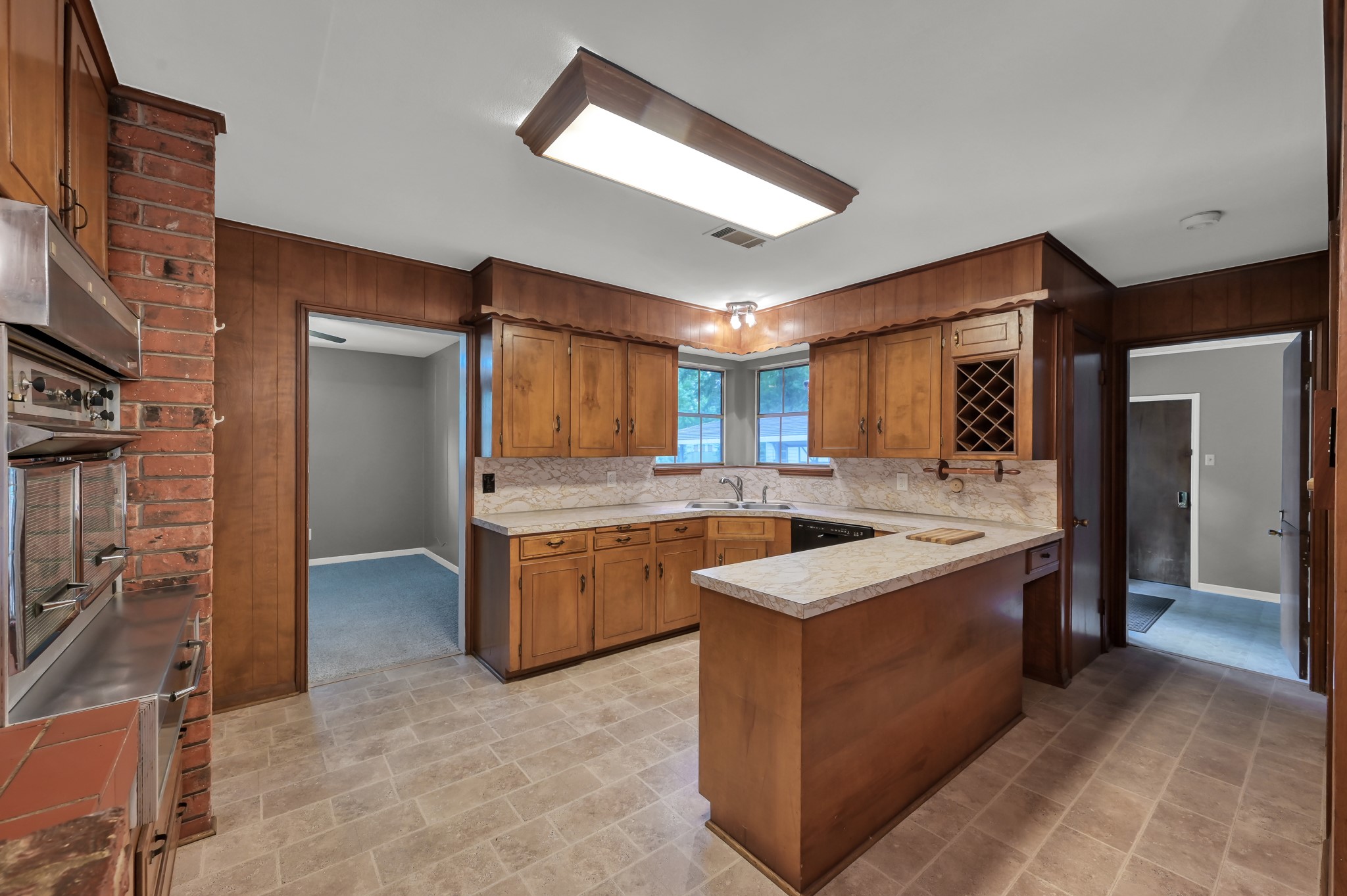 1251 Pruitt Road The Woodlands, TX 77380 - Photo 16 of 36 Kitchen with brick walls and mid century appliance package