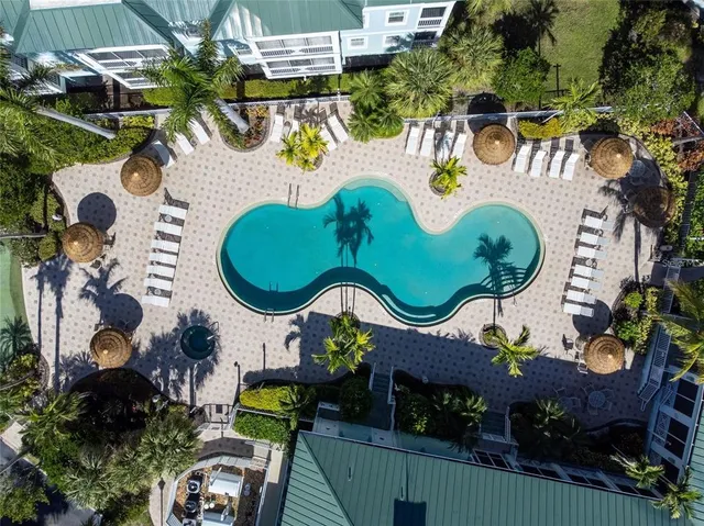 an aerial view of a swimming pool patio and outdoor seating