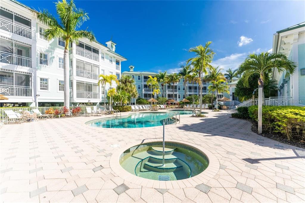 5123 Melbourne Street, Unit D203 Punta Gorda, FL 33980 - Photo 5 of 16 a swimming pool with outdoor seating and yard