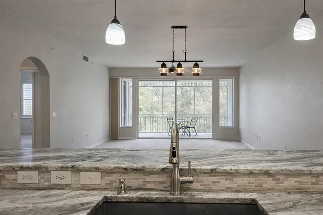 a view of a livingroom with a chandelier fan