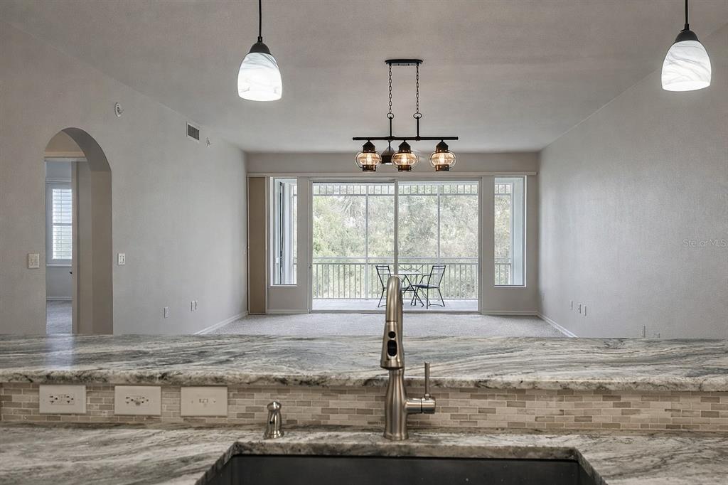 5123 Melbourne Street, Unit D203 Punta Gorda, FL 33980 - Photo 8 of 16 a view of a livingroom with a chandelier fan
