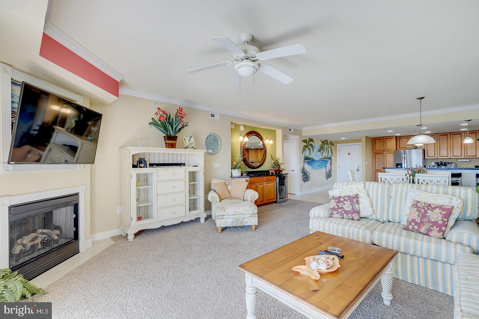 4601 Coastal Highway, Unit 403 Ocean City, MD 21842 - Photo 13 of 56 a living room with furniture and a fireplace
