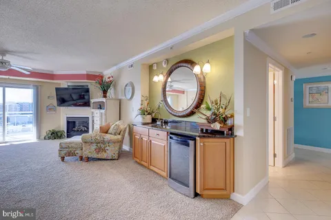 a living room with furniture a mirror and a fireplace