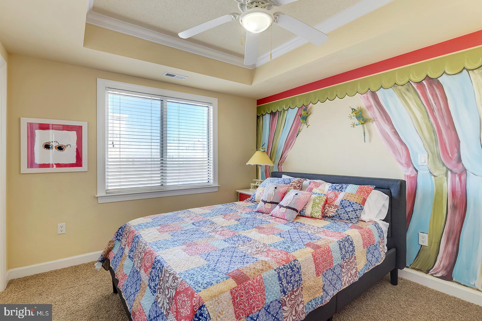 4601 Coastal Highway, Unit 403 Ocean City, MD 21842 - Photo 28 of 56 a bedroom with a bed and a painting on the wall