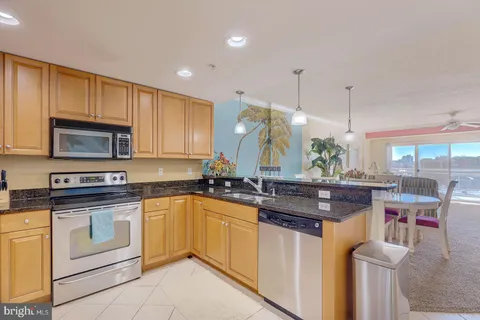 a kitchen with granite countertop a sink and cabinets