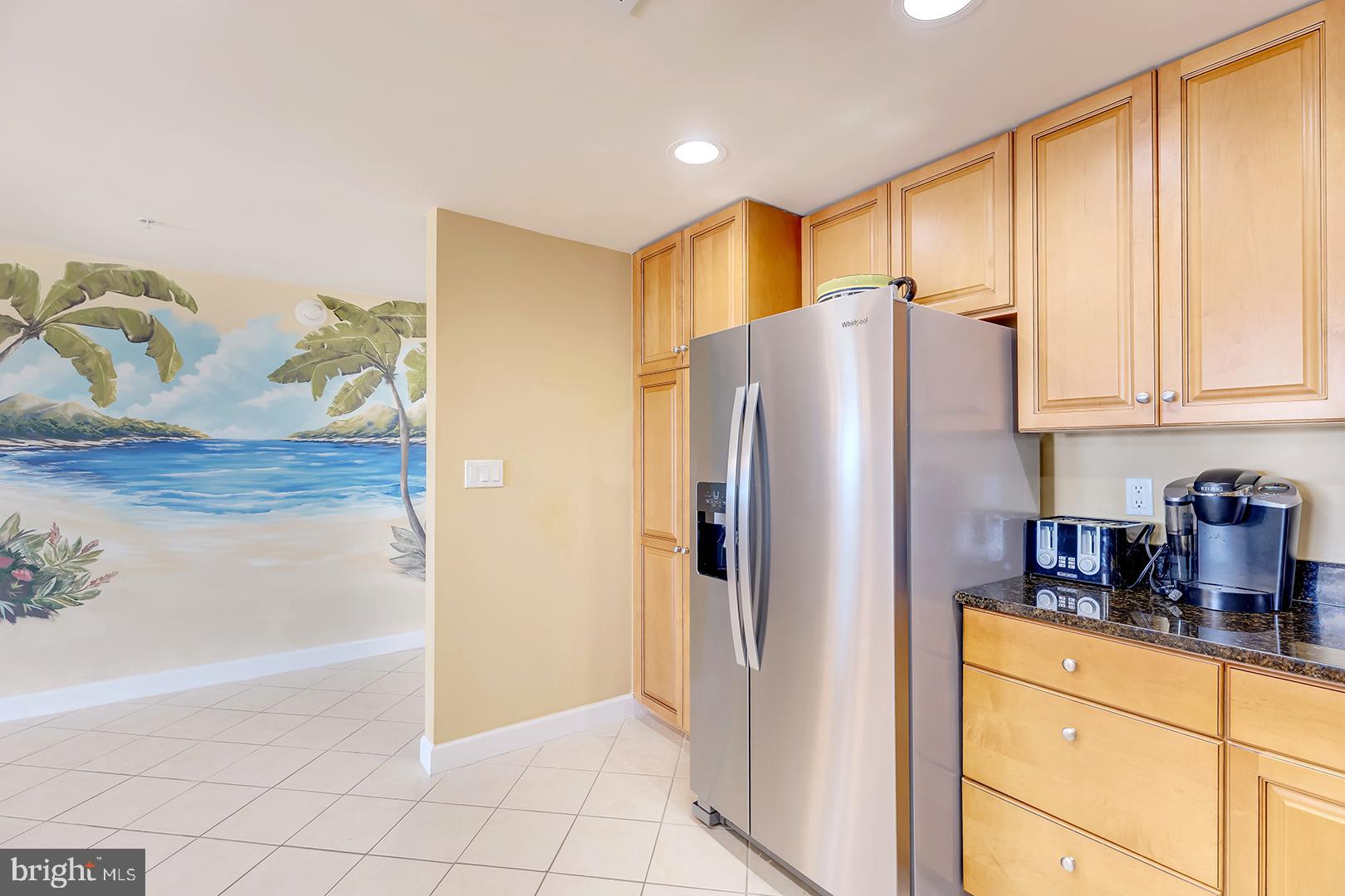 4601 Coastal Highway, Unit 403 Ocean City, MD 21842 - Photo 8 of 56 a kitchen with stainless steel appliances a refrigerator and a sink