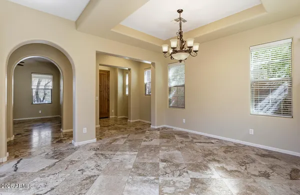 a view of a big room with wooden floor and windows