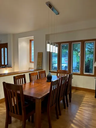 a dining room with furniture and wooden floor
