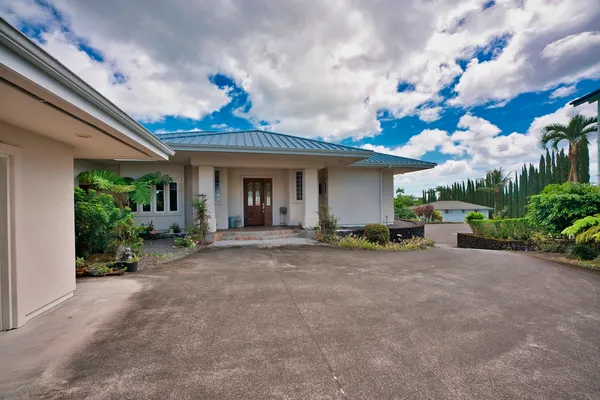 a view of a house with patio and garden