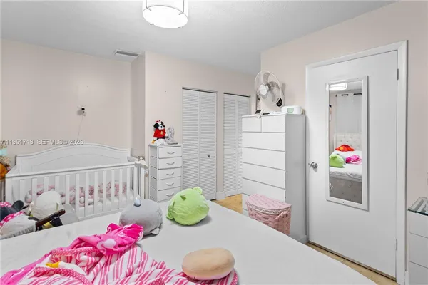 a bedroom with a bed and cabinets