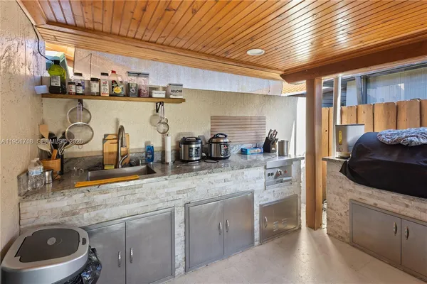 a kitchen with stainless steel appliances granite countertop a sink and cabinets